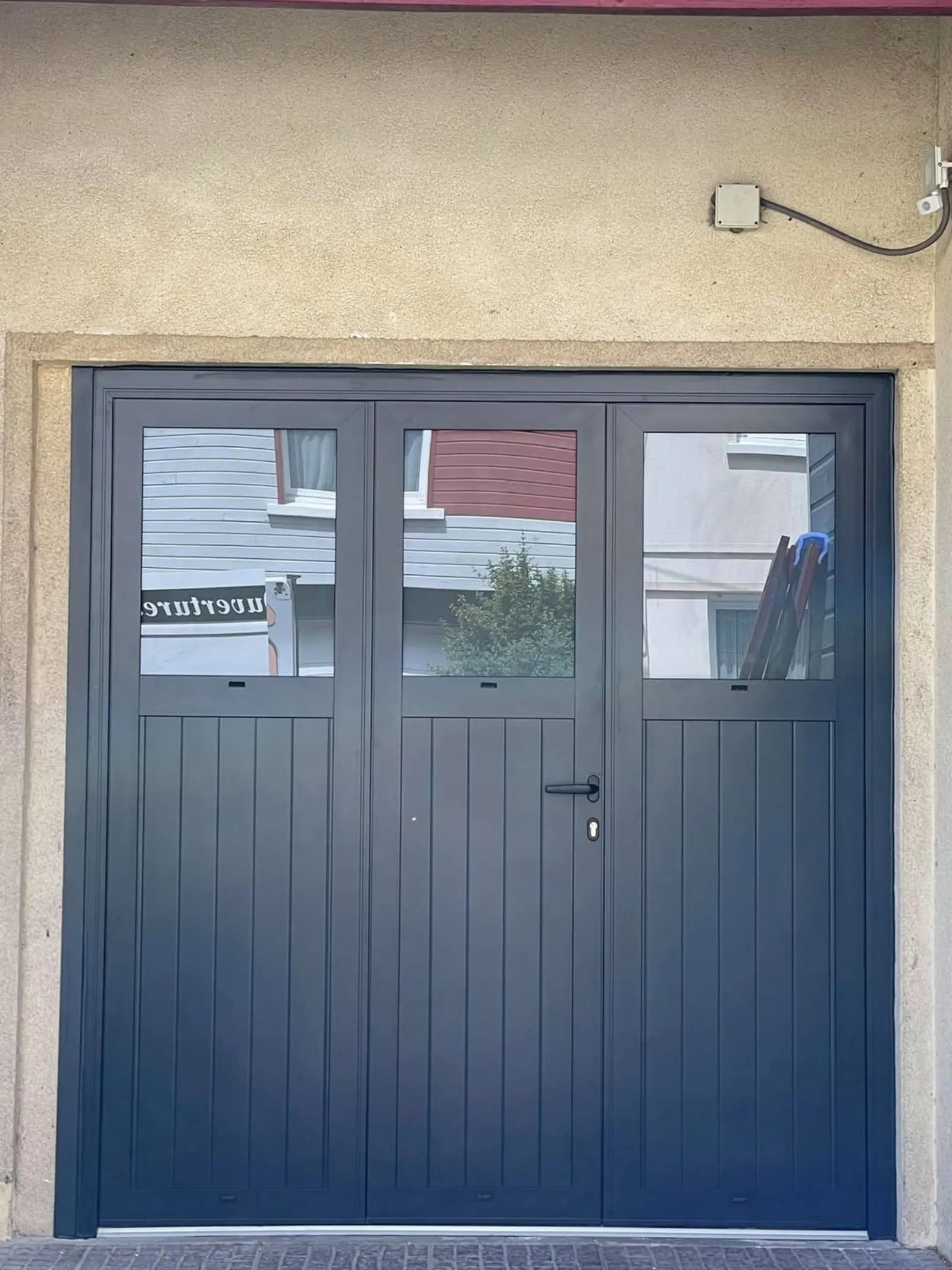 Porte de garage battante aluminium anthracite trois vantaux vitrés